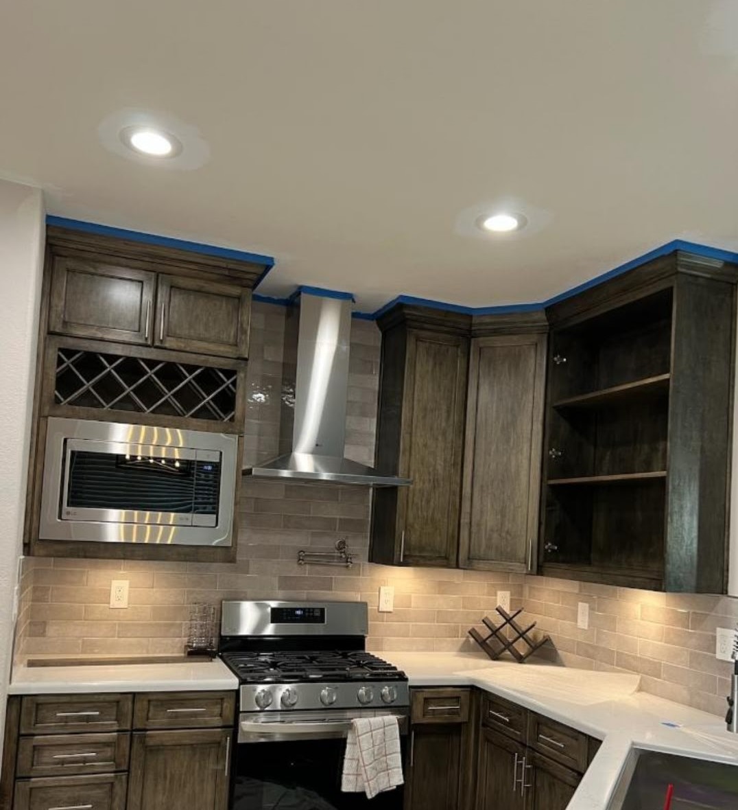 corner of a kitchen built by all pro builders - chrome appliances - lightbox