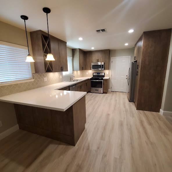 a kitchen renovation done by all pro builders - long C shape counter  